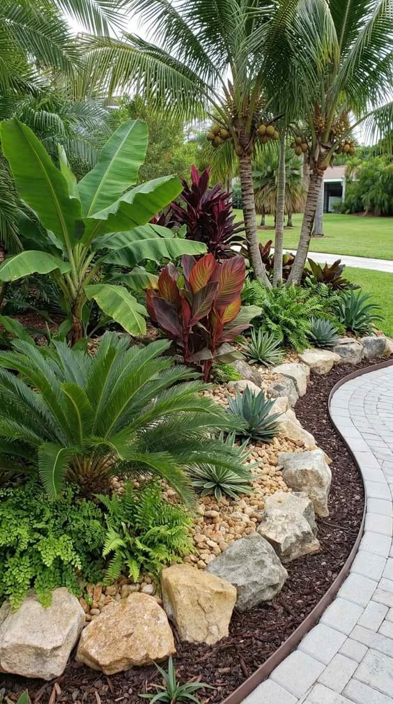 Tropical landscaping with palms, banana plants and stone borders